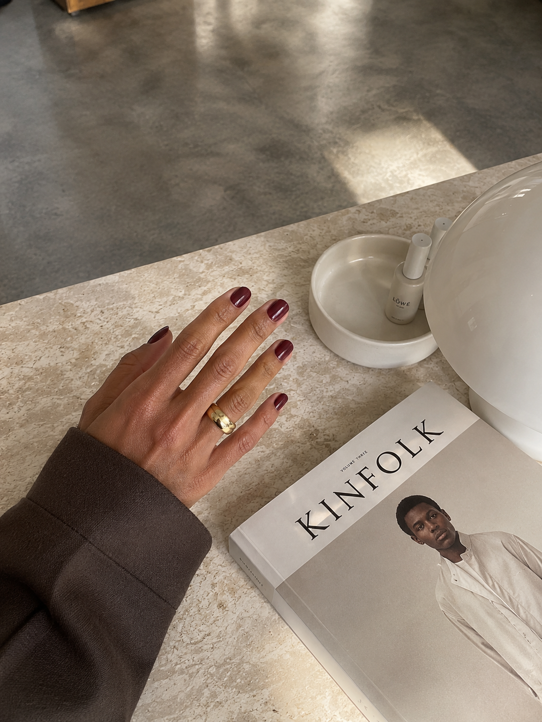 Soft nude manicure in the salon with warm sunlight