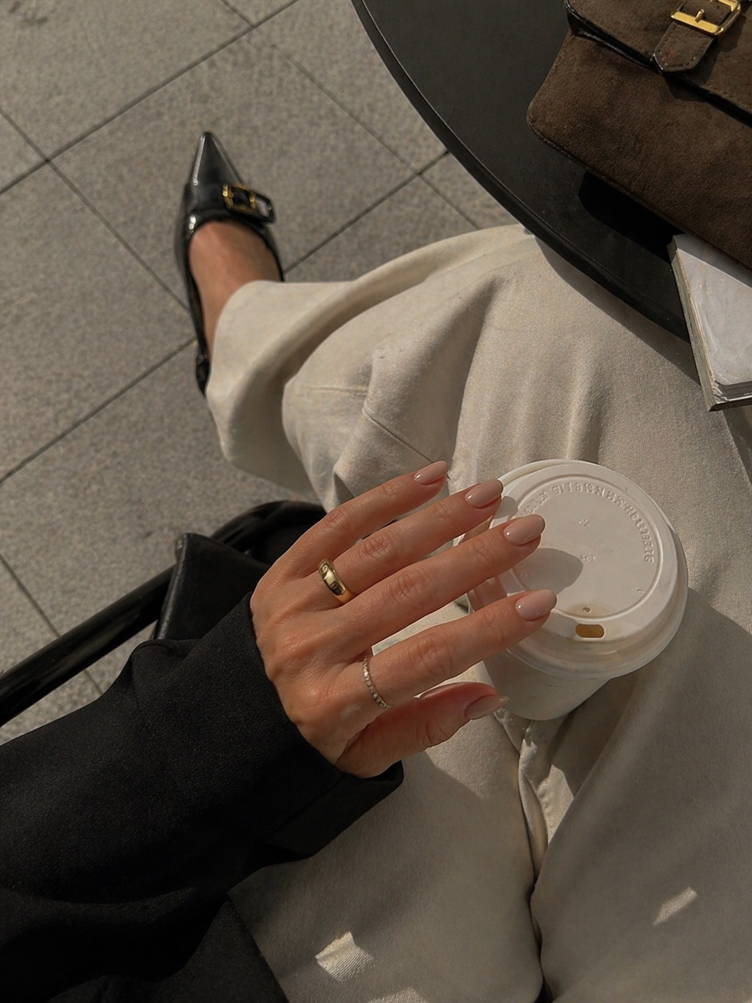 Minimal nude manicure styled with a blazer and leather bag