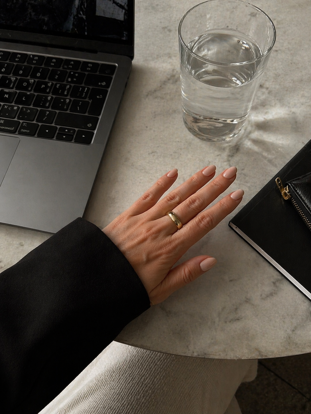 Minimal nude manicure holding a takeaway coffee cup